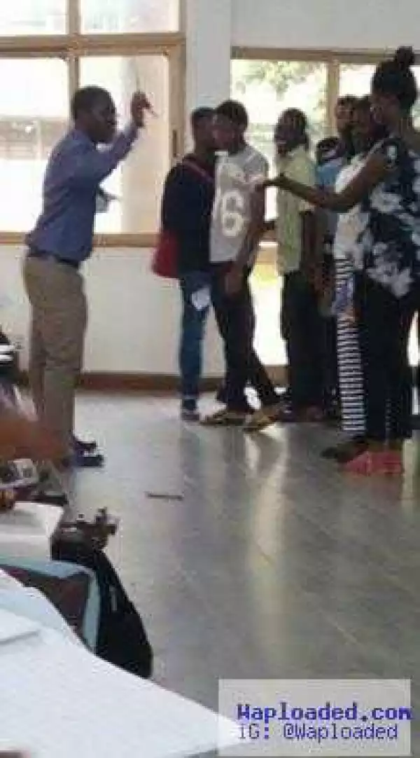 See photo of a University lecturer caning his students